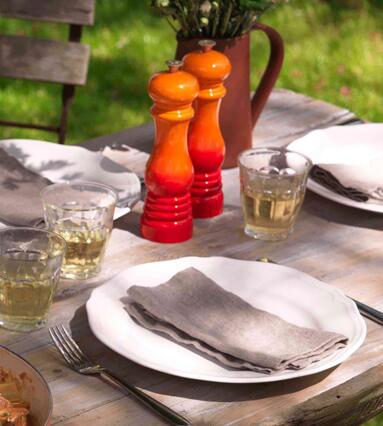 Le Creuset Pfeffermühle perlgrau auf gedecktem Gartentisch